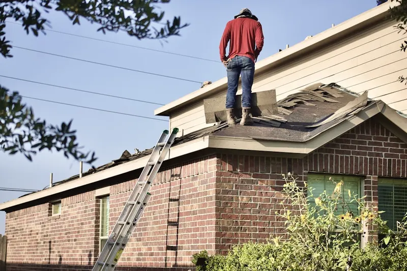 Professional roofer working on a residential roof in Bakersville